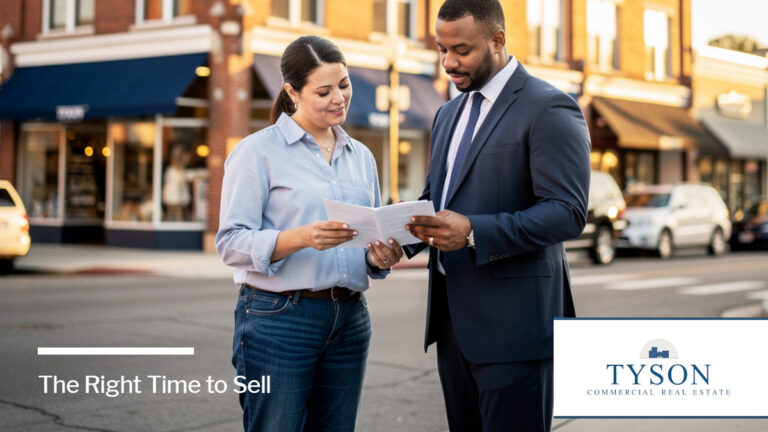 Two real estate investors look at some data on a property.